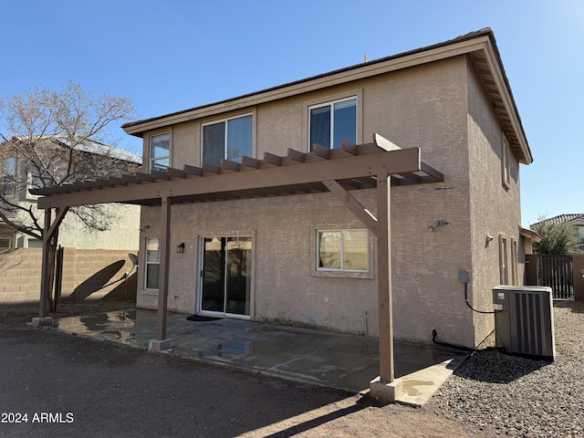 rear view of property featuring a patio, cooling unit, and a pergola