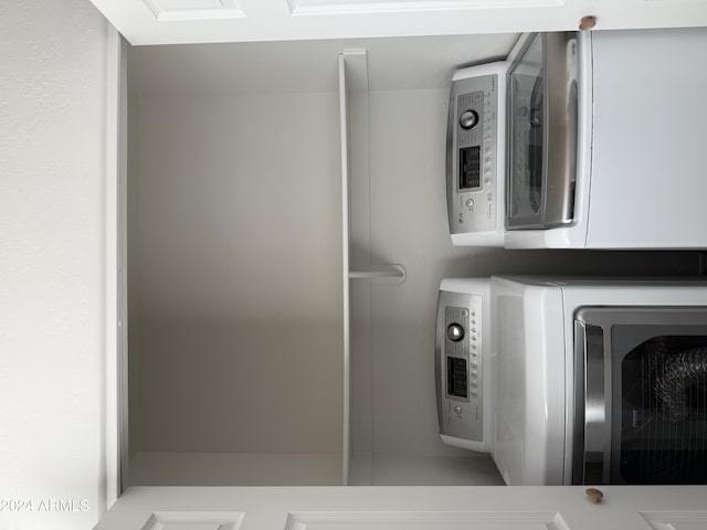 washroom with stacked washer and dryer