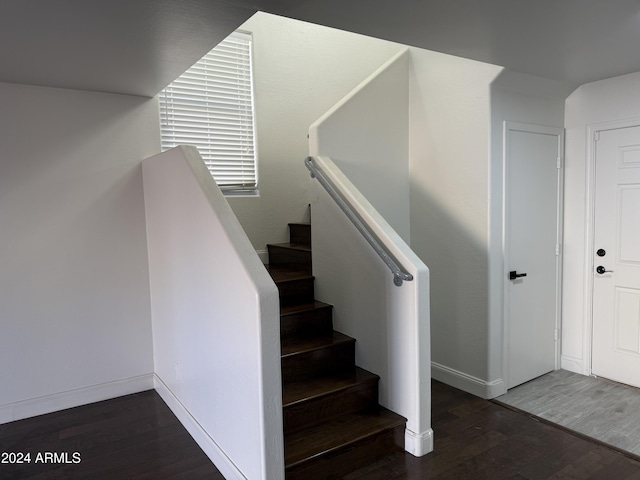 stairs featuring hardwood / wood-style floors