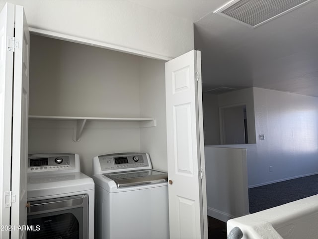 washroom with independent washer and dryer