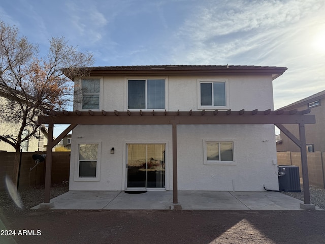 rear view of house with central AC and a patio area