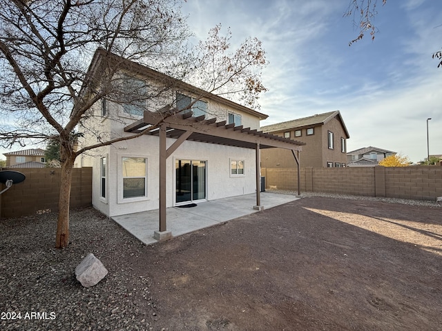 rear view of house with a pergola and a patio