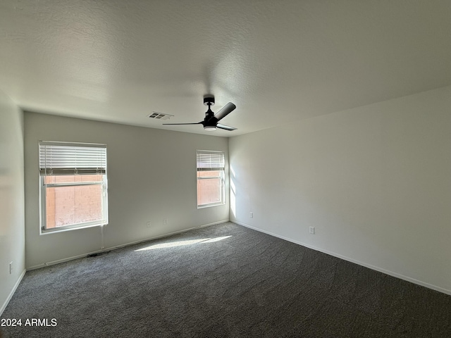 unfurnished room with ceiling fan and carpet flooring