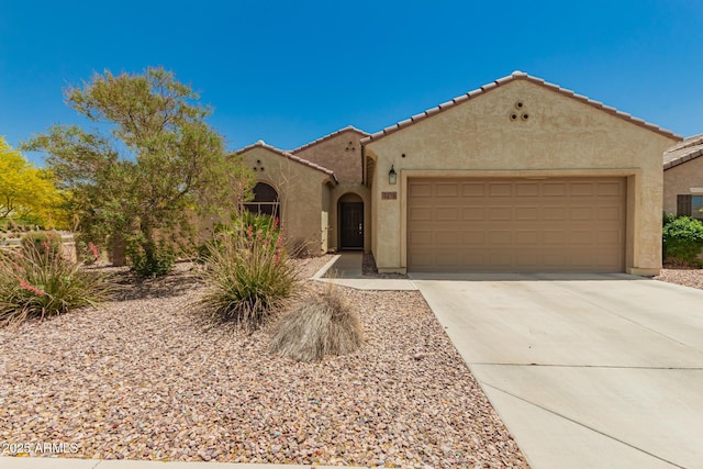 3453 N San Marin Dr, Florence, AZ 85132 - mediterranean / spanish-style home with stucco siding, a garage, driveway, and a tiled roof