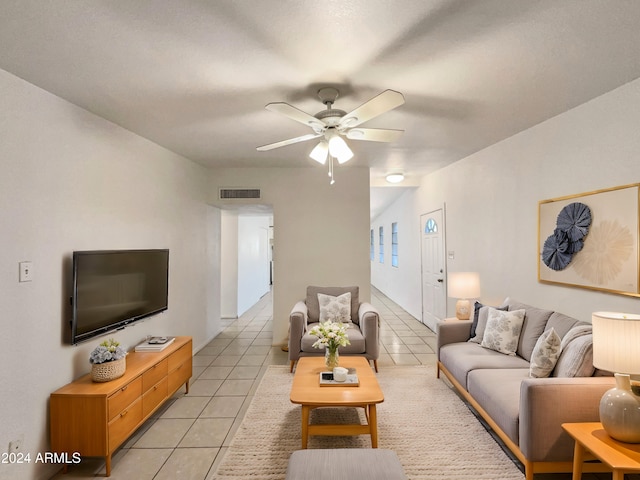 tiled living room featuring ceiling fan