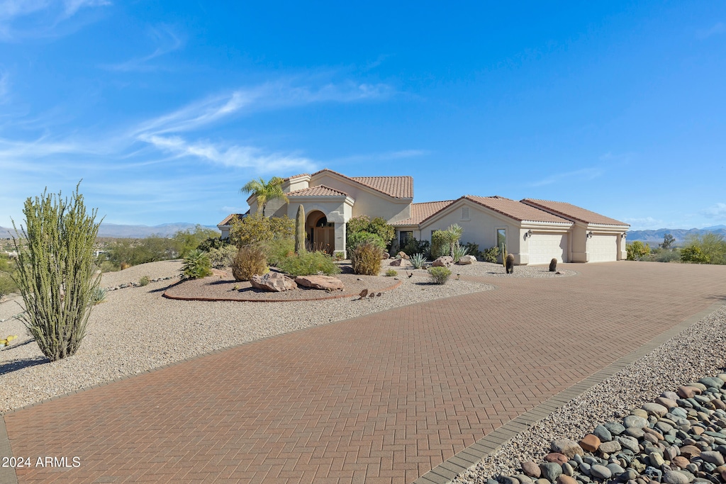 view of front of home with a garage and a mountain view