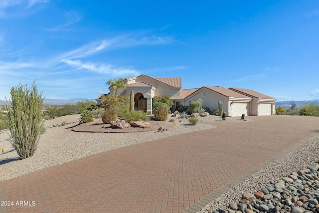 view of front of home with a garage and a mountain view