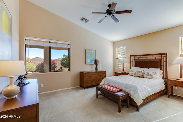 carpeted bedroom featuring vaulted ceiling, multiple windows, and ceiling fan