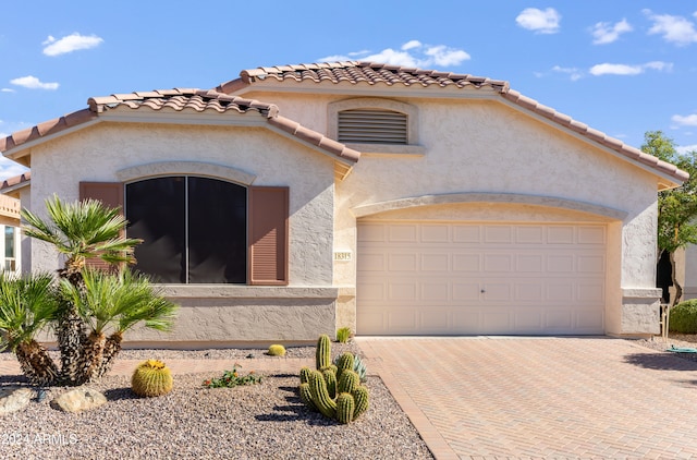 mediterranean / spanish house with a garage