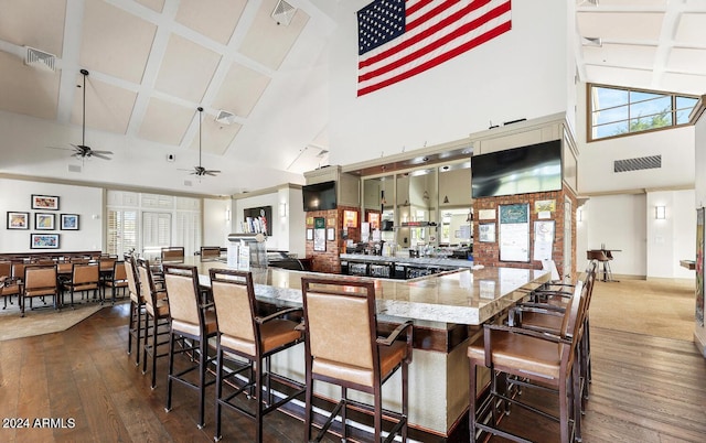 kitchen featuring plenty of natural light, ceiling fan, dark hardwood / wood-style flooring, and a high ceiling