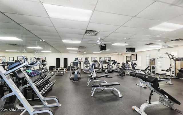 exercise room featuring a paneled ceiling and ceiling fan