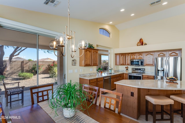 kitchen featuring lofted ceiling, sink, dark hardwood / wood-style floors, stainless steel appliances, and a chandelier