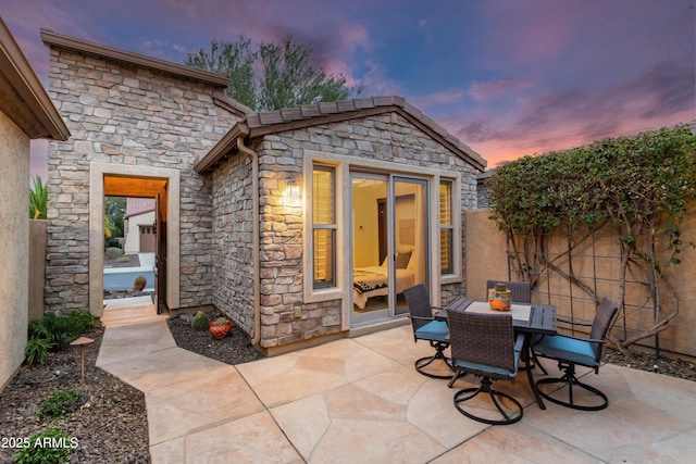 view of patio featuring outdoor dining space and fence