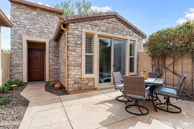 view of patio with fence and outdoor dining space