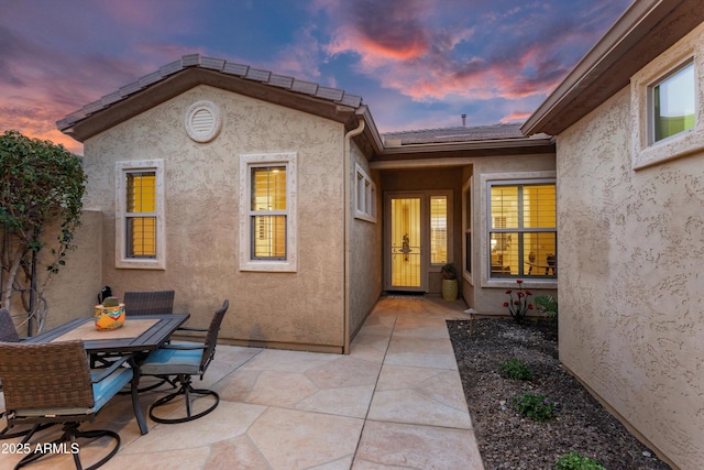 patio terrace at dusk with outdoor dining space