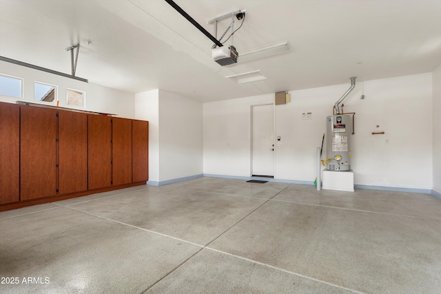 garage featuring baseboards, gas water heater, and a garage door opener