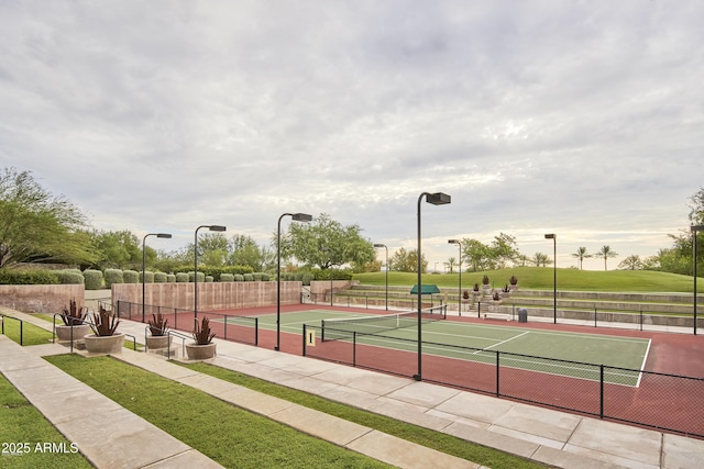 view of tennis court featuring fence