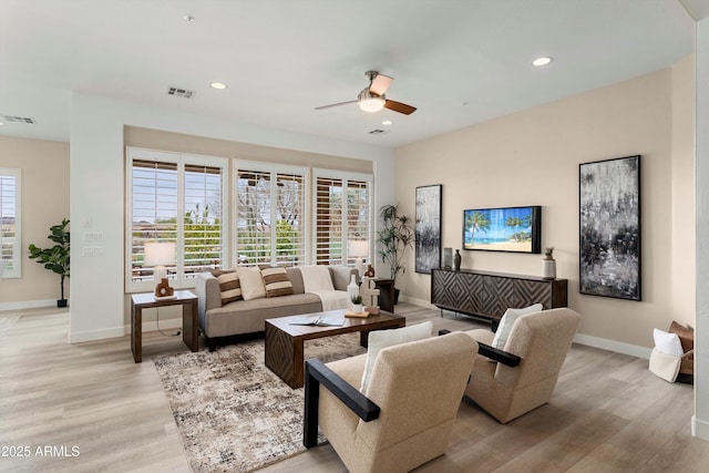 living area featuring light wood finished floors, visible vents, and recessed lighting