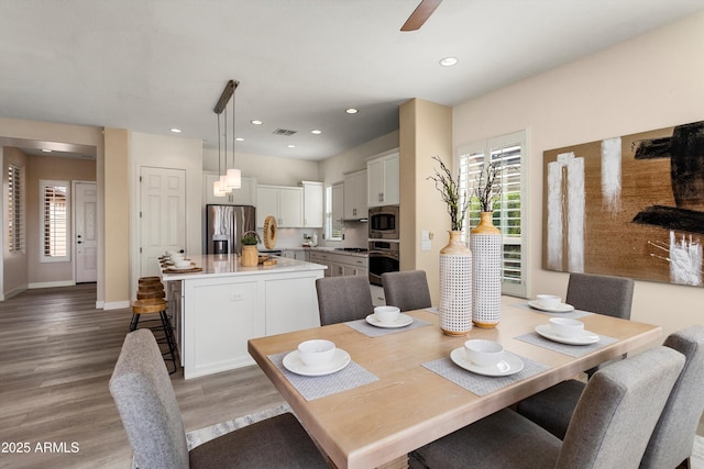 dining room with ceiling fan, recessed lighting, visible vents, baseboards, and light wood-style floors