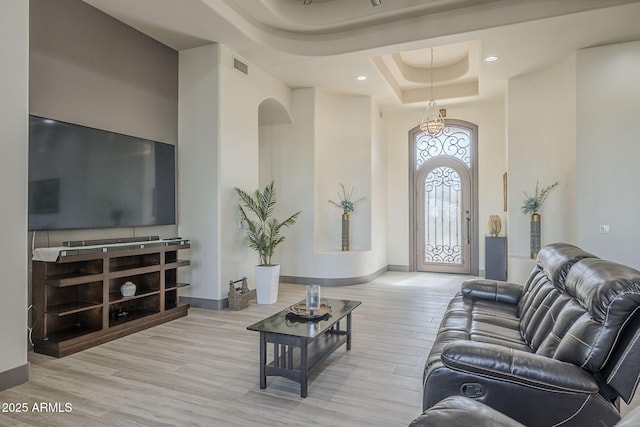 4915 N Greentree Dr, Litchfield Park, AZ 85340 - living room with a raised ceiling, a high ceiling, and light wood-type flooring
