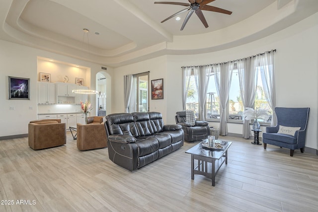 4915 N Greentree Dr, Litchfield Park, AZ 85340 - living room featuring ceiling fan, a tray ceiling, and light hardwood / wood-style floors
