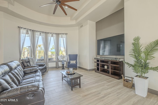 4915 N Greentree Dr, Litchfield Park, AZ 85340 - living room with ceiling fan, light wood-type flooring, and a tray ceiling