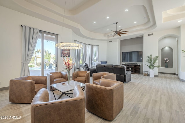 4915 N Greentree Dr, Litchfield Park, AZ 85340 - living room with a raised ceiling, a towering ceiling, ceiling fan, and light hardwood / wood-style flooring
