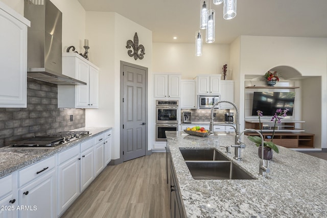 4915 N Greentree Dr, Litchfield Park, AZ 85340 - kitchen featuring stainless steel appliances, pendant lighting, wall chimney range hood, and white cabinets