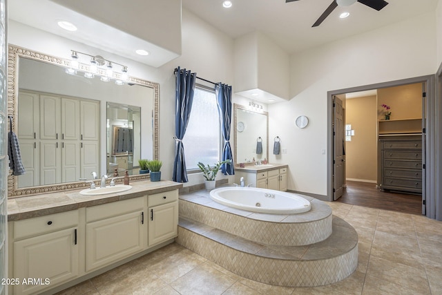 4915 N Greentree Dr, Litchfield Park, AZ 85340 - bathroom with ceiling fan, vanity, tiled bath, and tile patterned flooring