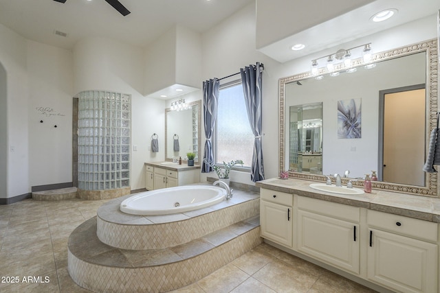 4915 N Greentree Dr, Litchfield Park, AZ 85340 - bathroom with ceiling fan, tile patterned floors, vanity, and tiled bath