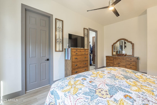 4915 N Greentree Dr, Litchfield Park, AZ 85340 - bedroom featuring a walk in closet, light hardwood / wood-style floors, a closet, and ceiling fan