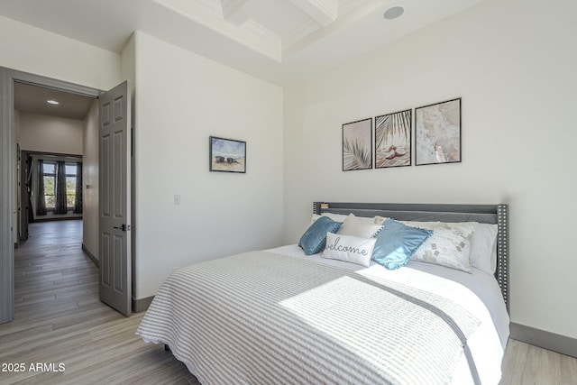4915 N Greentree Dr, Litchfield Park, AZ 85340 - bedroom featuring coffered ceiling, light hardwood / wood-style floors, and beamed ceiling
