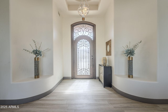 4915 N Greentree Dr, Litchfield Park, AZ 85340 - foyer entrance featuring a high ceiling, a chandelier, and light hardwood / wood-style flooring