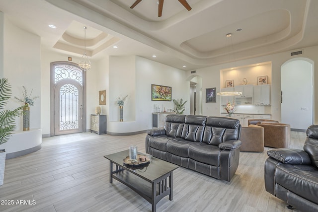 4915 N Greentree Dr, Litchfield Park, AZ 85340 - living room with a raised ceiling, ceiling fan, a towering ceiling, and light hardwood / wood-style floors