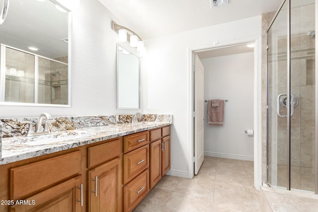 bathroom featuring vanity, an enclosed shower, and tile patterned flooring