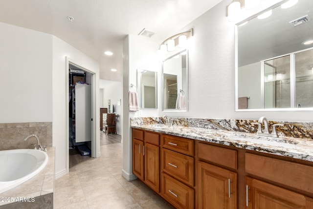 bathroom featuring vanity, tile patterned floors, and shower with separate bathtub