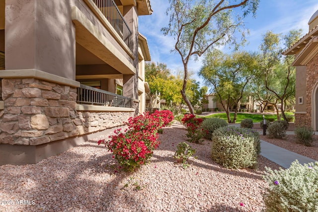 view of yard with a balcony