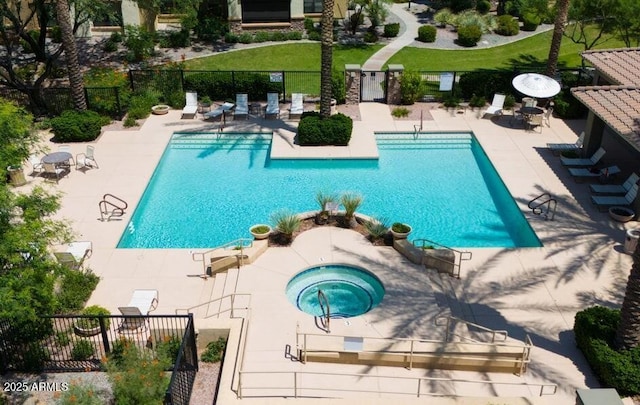 view of pool featuring a community hot tub and a patio