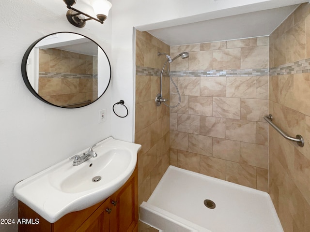 bathroom featuring vanity and tiled shower