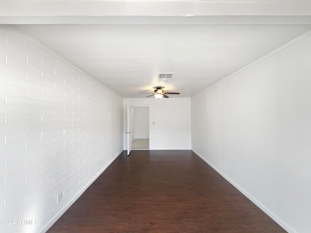 hall with brick wall and dark wood-type flooring