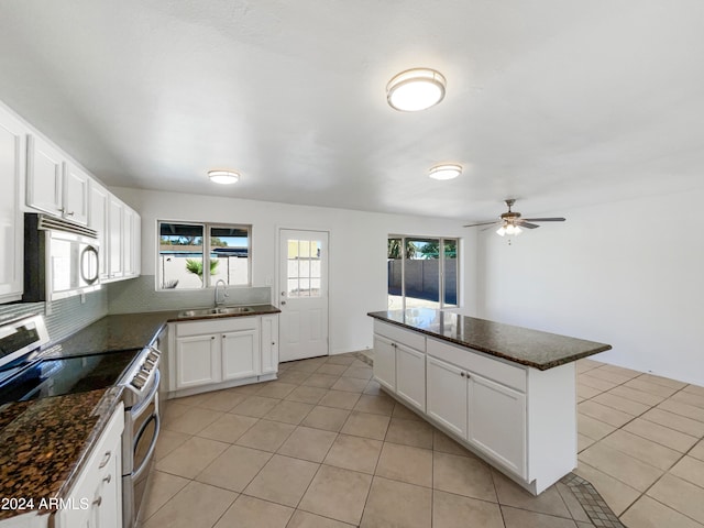 kitchen featuring white cabinets, stainless steel appliances, sink, and light tile patterned floors