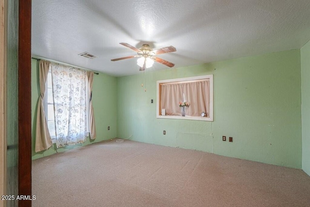 1055 S 4th St, Coolidge, AZ 85128 - unfurnished room with a textured ceiling, carpet, visible vents, and a ceiling fan