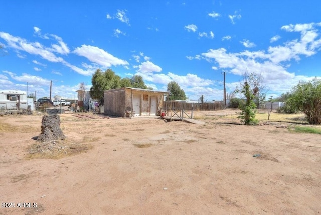 1055 S 4th St, Coolidge, AZ 85128 - view of yard featuring an outdoor structure, fence, and a shed