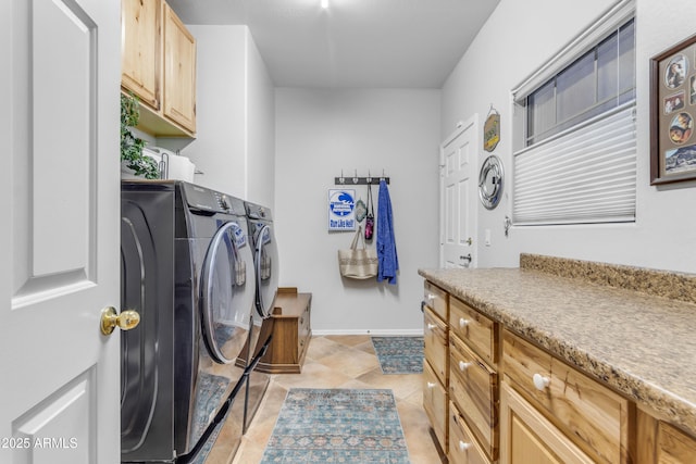 laundry area with cabinets, light tile patterned flooring, and separate washer and dryer