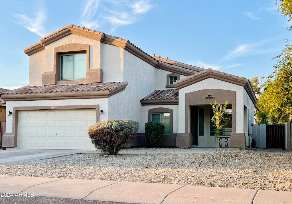 mediterranean / spanish home with a garage