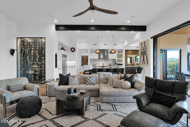 living room with beam ceiling and ceiling fan