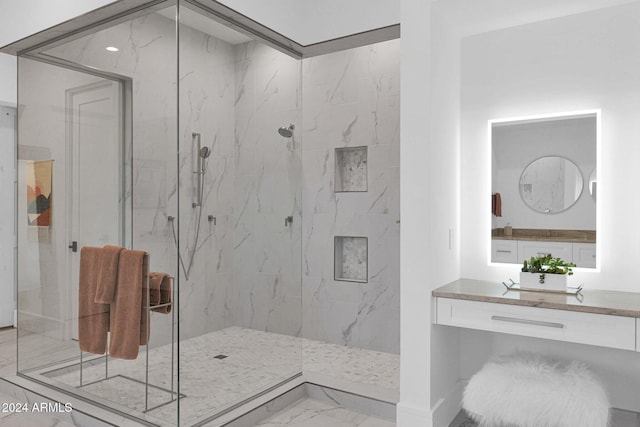 bathroom featuring tiled shower and vanity