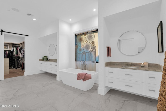 bathroom with vanity and a bath