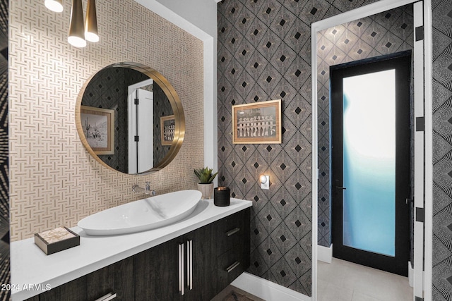 bathroom with tile patterned floors, vanity, and tile walls