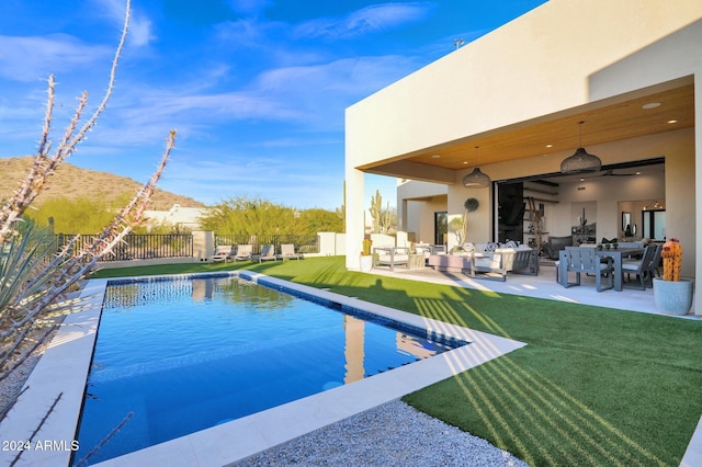 view of swimming pool featuring a patio and a lawn